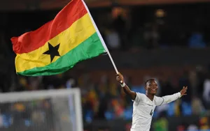 Ghana Athlete And Flag Wallpaper
