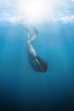 Girl Snorkeling Downwards Towards Sea Bed Wallpaper