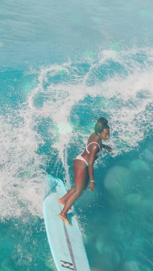 Girl Surfing On Blue Board Wallpaper