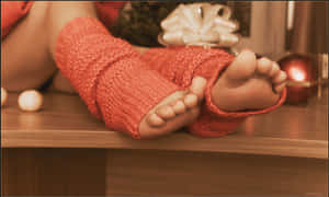 Girl’s Feet Dressed In Cozy Knitted Socks Wallpaper