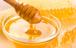 Glass Bowl Of Honey With Honeycomb Wallpaper