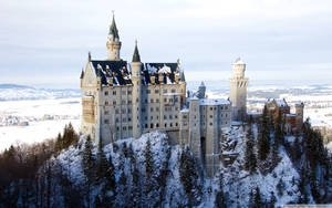 Glistening Neuschwanstein Castle During Winter Wallpaper
