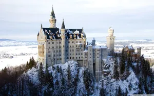 Glistening Neuschwanstein Castle During Winter Wallpaper