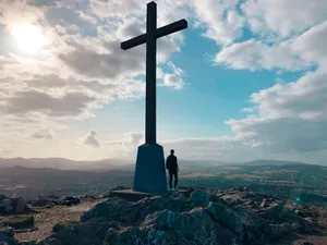 Golden Cross In Sunset Glow Wallpaper