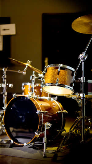 Golden Drum Set Stage Lighting Wallpaper