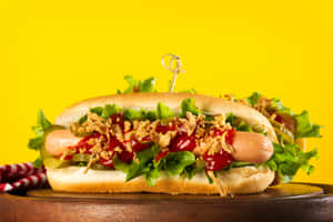 Gourmet Hot Dog Yellow Background.jpg Wallpaper