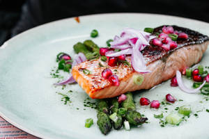 Gourmet-style Salmon Fillet Garnished With Fresh Herbs Wallpaper