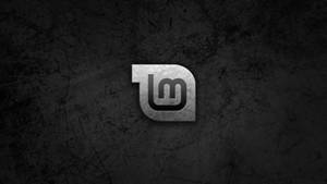 Gray Scratched Logo Of Linux Mint Operating System Wallpaper