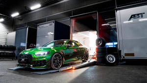 Green Audi Rs Exiting A Truck Wallpaper