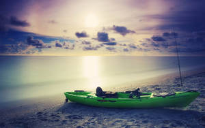 Green Kayak On A Beach Wallpaper