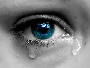 Greyscale Blue Eye Crying With Tears Wallpaper