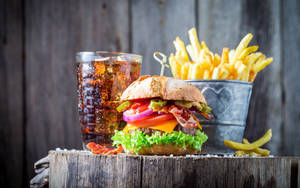 Grilled Cheeseburger With Ice Tea And Fries Wallpaper