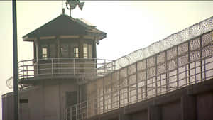 Gritty Prison Tower Standing Guard Wallpaper