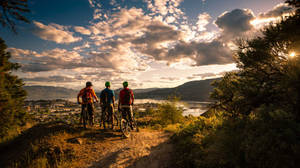 Group Of Friends Mountain Biking Knox Mountain Park Wallpaper