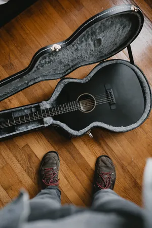 Guitar All Black On Floor Wallpaper