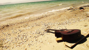 Guitar On Sunny Beach Wallpaper