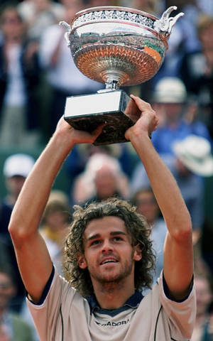 Gustavo Kuerten Holding His Trophy Up Wallpaper