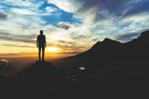 Guy Silhouette On A Hilltop At Sunrise Wallpaper