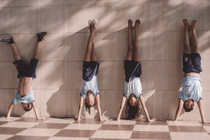 Gymnastics Handstand Against Wall Wallpaper