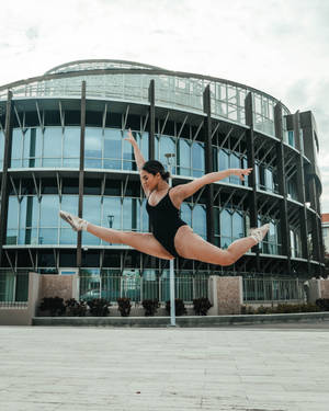 Gymnastics Near Glass Building Wallpaper