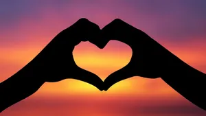 Hand Heart Silhouette In The Sunset Wallpaper