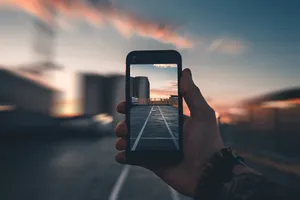 Hand Holding Smartphone Photo Wallpaper