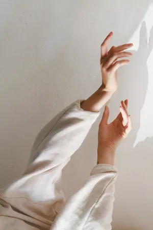 Hand Shadows On Soft White Aesthetic Wall Wallpaper