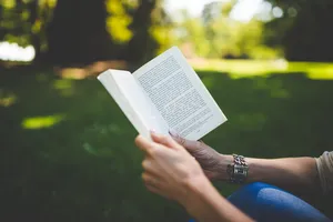 Hands Holding Open Book Wallpaper