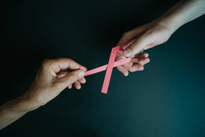 Hands Holding Ribbon Breast Cancer Awareness Wallpaper