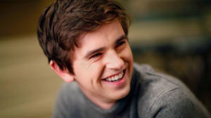 Happy Face Of Freddie Highmore Wallpaper