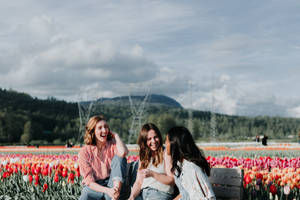 Happy Girls Best Friend In Tulips Field Wallpaper