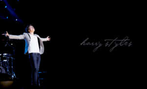 Harry Styles Clutching His Laptop Wallpaper