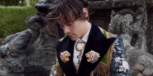 Harry Styles Hunches Over His Laptop Wallpaper