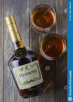 Hennessy Whiskey Bottle And Glasses On Wooden Background Wallpaper