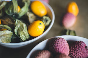 High Angle View Of Fresh Kumquat And Lychee Fruits Wallpaper