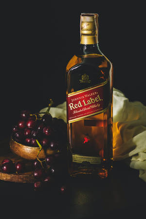 High-end Red Label Whiskey With Fresh Cherries Wallpaper