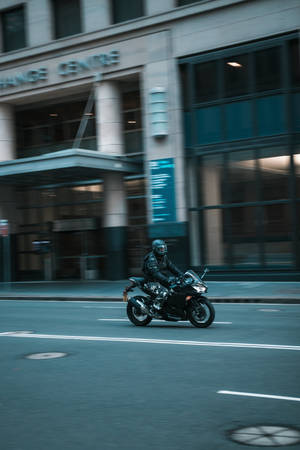 High Speed Luxury Car On The Move Wallpaper