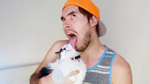 Holasoygerman Posing Playfully With His Cat Wallpaper