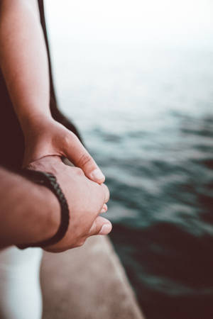 Holding Hands By The Sea Wallpaper