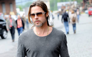 Hollywood Icon Brad Pitt Taking A Stroll Wallpaper