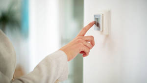 Human Hand Interacting With A Classic Light Switch Wallpaper