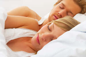 Husband And Wife Sleeping On Bed Wallpaper