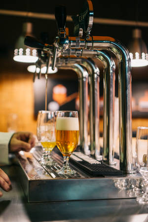 Ice-cold Beer On Tap In A Luxury Setting Wallpaper