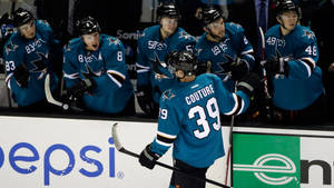 Ice Hockey Player Logan Couture Back Angle Shot And Teammates Wallpaper