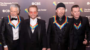 Iconic Band Members Rainbow Accents Event Wallpaper