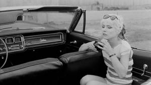 Iconic Debbie Harry Of Blondie In Vintage Car Photoshoot Wallpaper