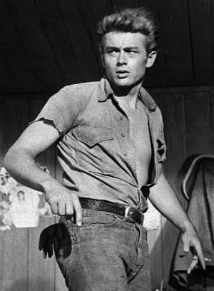 Iconic James Dean Smirking In Open Shirt Wallpaper