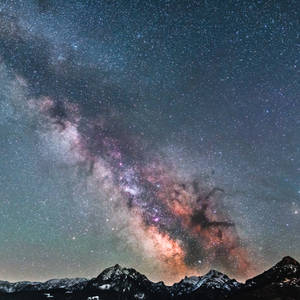 Icy Mountain Top Over The Milky Way Wallpaper