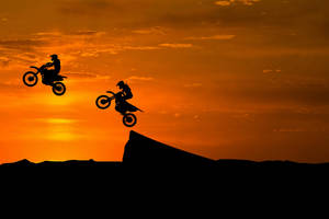 Igniting Passion – Extreme Sports Motocross Silhouette Wallpaper