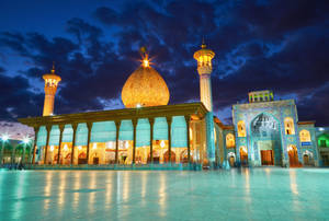 Illuminated Mosque Against Night Sky In Iran Wallpaper